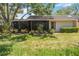 Beautiful backyard with screened-in lanai and lush landscaping at 269 Southampton Dr # 303, Venice, FL 34293