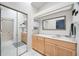 Well-lit bathroom boasts a vanity with ample storage, large mirror, and walk-in shower at 269 Southampton Dr # 303, Venice, FL 34293