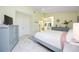 Neutral bedroom with a ceiling fan, an ensuite bathroom, and tiled floors at 269 Southampton Dr # 303, Venice, FL 34293