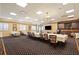 Well-lit conference room with long tables, stylish seating, and modern lighting fixtures create an inviting space at 269 Southampton Dr # 303, Venice, FL 34293