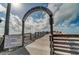 Scenic fishing pier featuring an arched entrance, rules signage, wooden deck, and ocean views, providing a recreational space at 269 Southampton Dr # 303, Venice, FL 34293