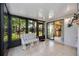 Enclosed lanai featuring bright, natural light, neutral colored tiles, and access to the kitchen at 269 Southampton Dr # 303, Venice, FL 34293