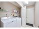 Functional laundry room with full sized washer and dryer and extra storage shelving at 269 Southampton Dr # 303, Venice, FL 34293
