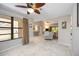 Open-concept living room with tile floors, neutral paint, ceiling fans, and large windows at 269 Southampton Dr # 303, Venice, FL 34293