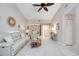 Expansive living room featuring ceiling fan, neutral decor, and fluid transition to foyer and other spaces at 269 Southampton Dr # 303, Venice, FL 34293