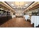Elegant lounge area with hardwood floors, cozy seating, a chandelier, and ample space for socializing at 269 Southampton Dr # 303, Venice, FL 34293