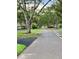 Quiet street surrounded by lush landscaping and mature trees in a well-maintained neighborhood at 269 Southampton Dr # 303, Venice, FL 34293