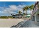 Beachfront restaurant exterior with palm trees and a vibrant atmosphere, perfect for seaside dining at 269 Southampton Dr # 303, Venice, FL 34293