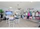 Boutique retail area with tennis apparel, display racks, and comfortable seating at 269 Southampton Dr # 303, Venice, FL 34293