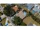 Aerial view of home with an enclosed pool, mature trees, and a nicely landscaped yard at 271 Manor Rd, Venice, FL 34293