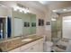 Bright bathroom with double granite vanity, toilet, and black and white tile at 271 Manor Rd, Venice, FL 34293