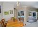 Dining area overlooking pool with sliding glass doors and elegant chandelier lighting at 271 Manor Rd, Venice, FL 34293