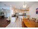 Open concept dining room and kitchen with white tile floor and crown molding at 271 Manor Rd, Venice, FL 34293