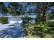 Charming home exterior showcasing a well-manicured lawn and large shade tree over the front yard at 271 Manor Rd, Venice, FL 34293