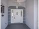 Stylish front entrance with a white door, accented by a fan and a unique blue-gray trim at 271 Manor Rd, Venice, FL 34293