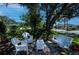 Inviting front yard setting with white wicker seating, a stone patio and a charming porch swing at 271 Manor Rd, Venice, FL 34293