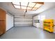 Clean, well-lit garage with epoxy floor, storage cabinets, and a modern garage door opener at 271 Manor Rd, Venice, FL 34293