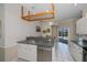 Modern kitchen with stainless steel sink, dishwasher, and access to the pool area at 271 Manor Rd, Venice, FL 34293