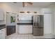 Bright kitchen featuring white cabinets, stainless steel refrigerator, and decorative accents at 271 Manor Rd, Venice, FL 34293