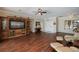 Large living room featuring hardwood floors, a built-in entertainment center, and comfortable seating at 271 Manor Rd, Venice, FL 34293