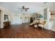 Open-concept living room with hardwood floors, neutral walls, comfortable seating and lots of natural light at 271 Manor Rd, Venice, FL 34293