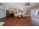 Expansive living room with hardwood floors, comfortable seating, and views of both the piano and pool areas at 271 Manor Rd, Venice, FL 34293