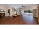 Spacious living room with wood floors, comfortable seating, and sliding glass doors to a screened pool area at 271 Manor Rd, Venice, FL 34293