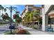 Enjoy outdoor dining at a cafe with shaded seating, colorful flowers, and views of the street at 271 Manor Rd, Venice, FL 34293