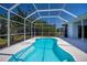 Enclosed pool with clear blue water, patio, and surrounding landscaping at 271 Manor Rd, Venice, FL 34293