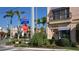 Charming street view in Venice featuring a variety of shops, palm trees, lush landscaping, and inviting storefronts at 271 Manor Rd, Venice, FL 34293