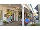 Quaint street scene with local shops, outdoor seating, and people enjoying the vibrant atmosphere of a small historic town at 271 Manor Rd, Venice, FL 34293
