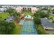 Aerial view of the condo complex, pool, tennis courts, and shuffleboard in a well-maintained community at 3006 Caring Way # 304, Port Charlotte, FL 33952