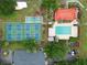 Aerial view of community pool, tennis courts, and shuffleboard, offering diverse recreational amenities for residents at 3006 Caring Way # 304, Port Charlotte, FL 33952