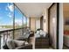 A screened balcony with wicker furniture offers a comfortable outdoor living space and clear sky views at 3006 Caring Way # 304, Port Charlotte, FL 33952