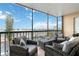A screened balcony with wicker furniture provides an outdoor living space with clear sky views at 3006 Caring Way # 304, Port Charlotte, FL 33952
