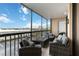 Screened balcony featuring wicker furniture, a coffee table and outdoor seating with sunny sky views at 3006 Caring Way # 304, Port Charlotte, FL 33952