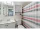 The bathroom features a combination shower and tub as well as a vanity with a mirror at 3006 Caring Way # 304, Port Charlotte, FL 33952
