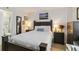 A bedroom with warm lighting highlighting the furniture, painting, and a glimpse of the bathroom at 3006 Caring Way # 304, Port Charlotte, FL 33952