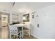 Cozy dining area features white table and chairs with a view into the kitchen and ample lighting at 3006 Caring Way # 304, Port Charlotte, FL 33952