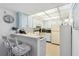 This galley kitchen offers a breakfast bar, tile floors, and bright recessed lighting at 3006 Caring Way # 304, Port Charlotte, FL 33952