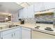 The open kitchen has light blue cabinets and neutral countertops, as well as updated appliances at 3006 Caring Way # 304, Port Charlotte, FL 33952
