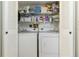 Laundry closet with side by side washer and dryer and storage shelf above at 3006 Caring Way # 304, Port Charlotte, FL 33952