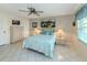 Comfortable bedroom with tile flooring, ceiling fan, and ample closet space at 3167 Night Heron Ln, Venice, FL 34293