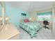 Light-filled bedroom featuring tile floors, a ceiling fan, and a dedicated desk area at 3167 Night Heron Ln, Venice, FL 34293