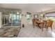 Bright dining room with tiled floors, direct access to sunroom and backyard views at 3167 Night Heron Ln, Venice, FL 34293