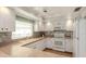 Modern kitchen with white cabinets, updated appliances, a tiled backsplash and wood-look flooring for an elegant touch at 3167 Night Heron Ln, Venice, FL 34293