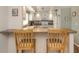 Bright kitchen featuring a breakfast bar, white cabinets, and sleek appliances for a modern cooking experience at 3167 Night Heron Ln, Venice, FL 34293