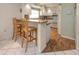 Well-lit kitchen area with a breakfast bar, white cabinetry, and modern appliances for a delightful cooking experience at 3167 Night Heron Ln, Venice, FL 34293