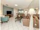 Inviting living room featuring tile floors, plush leather couches, and a decorative mirror wall for an open feel at 3167 Night Heron Ln, Venice, FL 34293