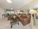 Comfortable living area boasts tile flooring, mirrored wall, and cozy seating, perfect for relaxation and entertaining at 3167 Night Heron Ln, Venice, FL 34293